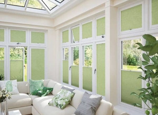 Green venetian blinds in a conservatory
